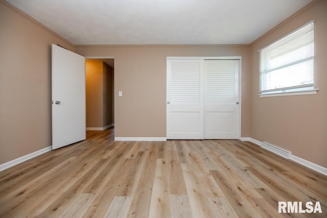 470 E Hazelwood St, Morton, IL 61550 - unfurnished bedroom featuring crown molding, a closet, and wood finished floors