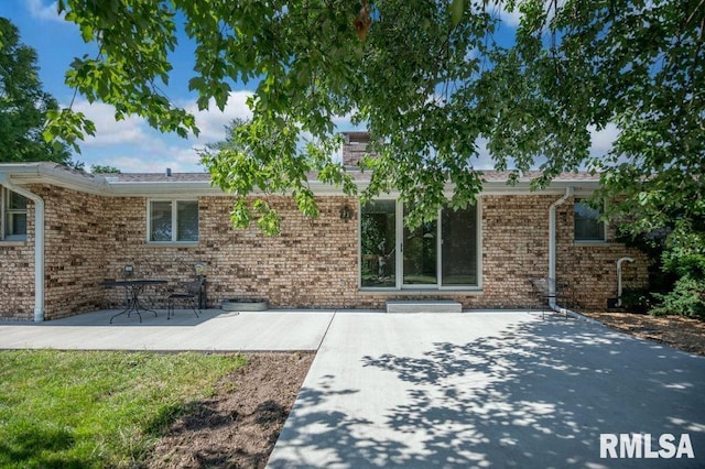 470 E Hazelwood St, Morton, IL 61550 - view of front of house with a patio, brick siding, and a chimney