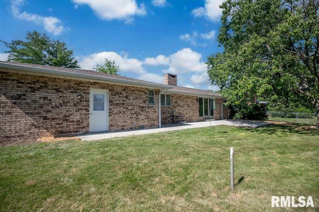 470 E Hazelwood St, Morton, IL 61550 - rear view of house featuring a chimney, a patio, and brick siding