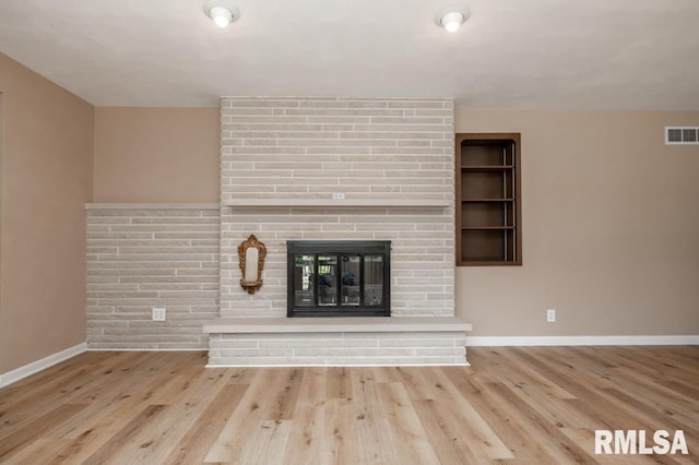 470 E Hazelwood St, Morton, IL 61550 - unfurnished living room featuring wood finished floors and a fireplace