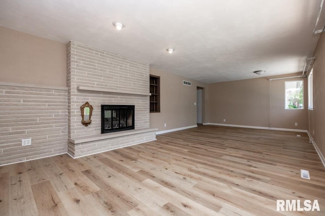 470 E Hazelwood St, Morton, IL 61550 - unfurnished living room featuring wood finished floors and a brick fireplace