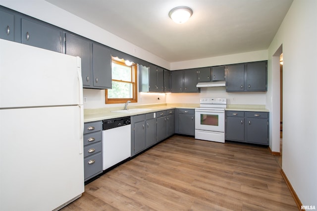 339 N Dr, Morton, IL 61550 - kitchen featuring white appliances, under cabinet range hood, wood finished floors, and light countertops