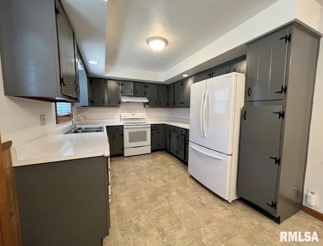 337 N Dr, Morton, IL 61550 - kitchen featuring white appliances, under cabinet range hood, light countertops, light tile patterned flooring, and a tray ceiling