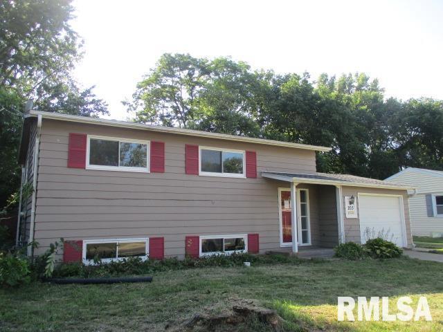 203 Arrow St, Pekin, IL 61554 - split level home with a garage and a front yard
