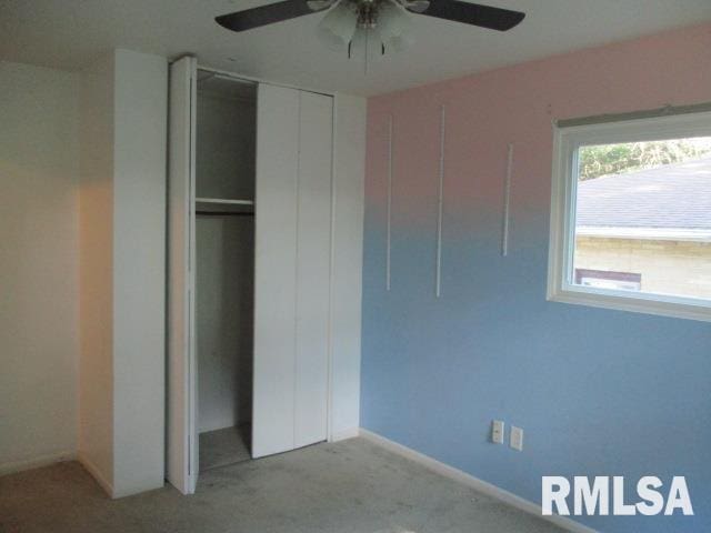 203 Arrow St, Pekin, IL 61554 - unfurnished bedroom featuring a closet, carpet flooring, and ceiling fan