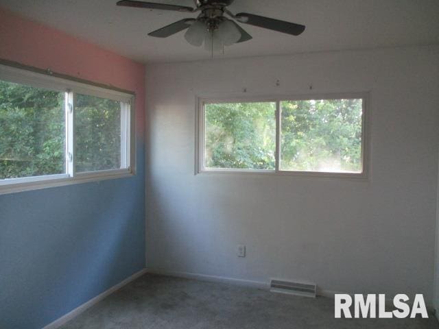 203 Arrow St, Pekin, IL 61554 - carpeted empty room featuring a ceiling fan and baseboards