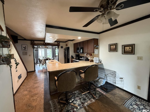 628 E Macarthur Ave, Lewistown, IL 61542 - kitchen featuring ornamental molding, black appliances, a peninsula, a ceiling fan, and dark brown cabinets