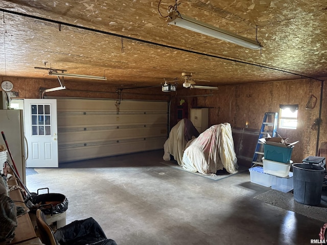 628 E Macarthur Ave, Lewistown, IL 61542 - garage with freestanding refrigerator and a garage door opener
