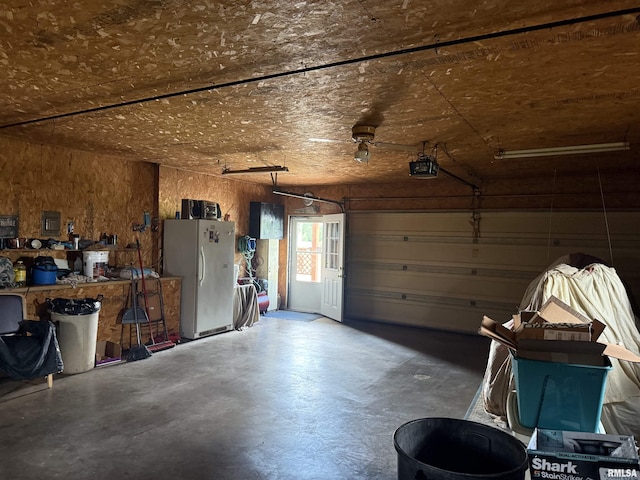 628 E Macarthur Ave, Lewistown, IL 61542 - garage featuring freestanding refrigerator and a garage door opener