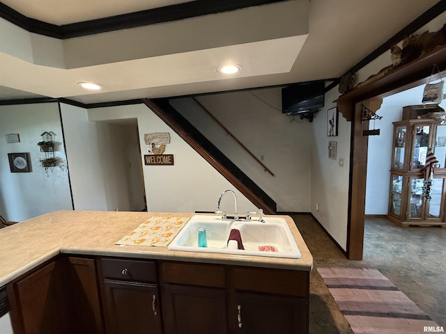 628 E Macarthur Ave, Lewistown, IL 61542 - kitchen with light countertops, dark brown cabinetry, recessed lighting, crown molding, and dark carpet