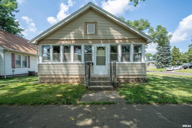 339 Herman St, Pekin, IL 61554 - bungalow-style home with a front lawn and board and batten siding
