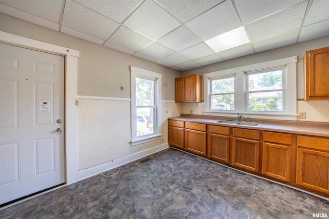 339 Herman St, Pekin, IL 61554 - kitchen featuring brown cabinets, stone finish flooring, a drop ceiling, and light countertops