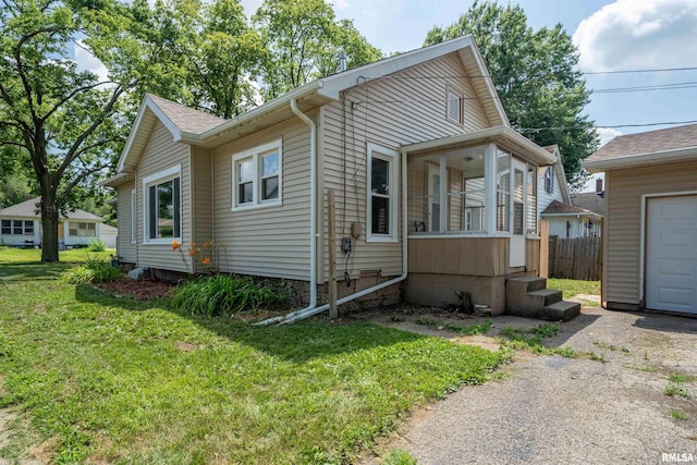 339 Herman St, Pekin, IL 61554 - view of front facade with a garage and a sunroom