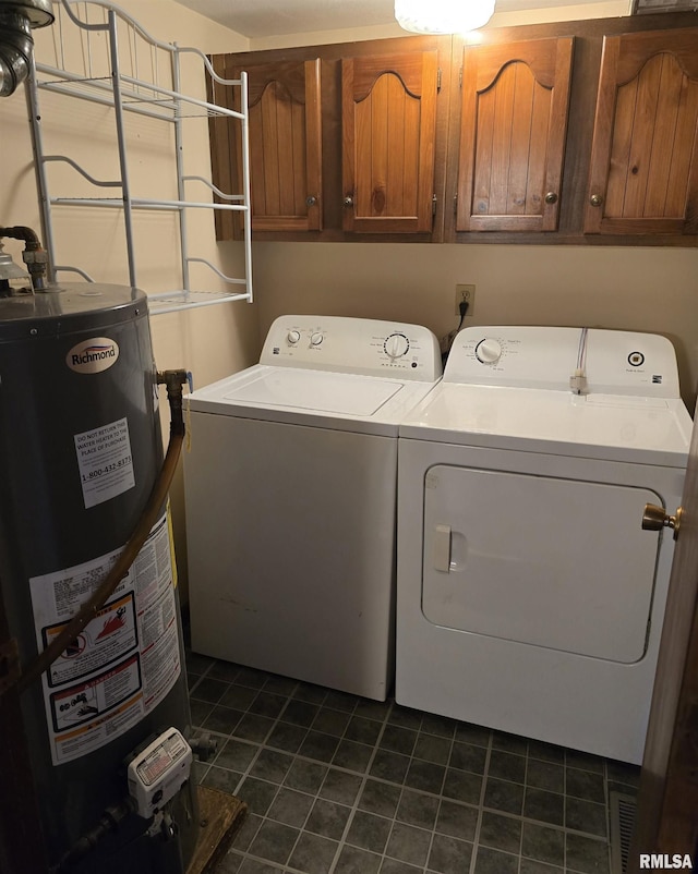403 Koch St, Pekin, IL 61554 - laundry room with cabinet space, washer and dryer, gas water heater, and dark tile patterned flooring