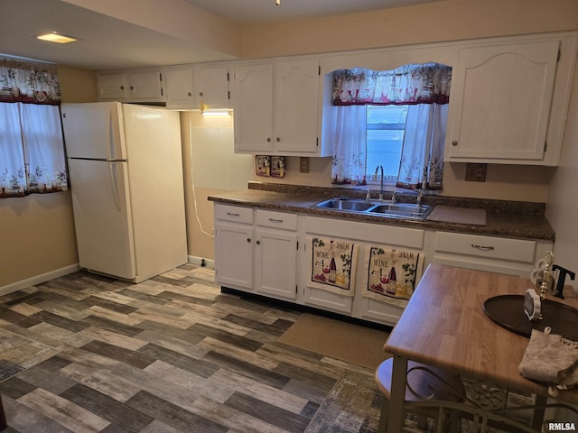 403 Koch St, Pekin, IL 61554 - kitchen featuring freestanding refrigerator, white cabinets, dark countertops, and dark wood-style floors