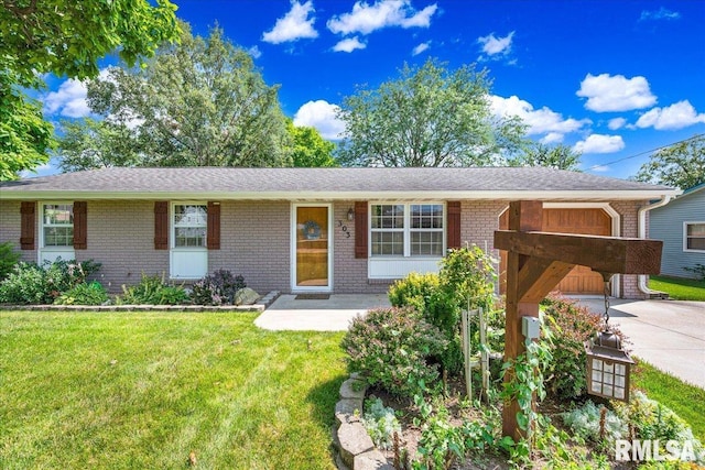 303 W 3rd Ave, Deer Creek, IL 61733 - single story home featuring brick siding, driveway, a front lawn, and a garage