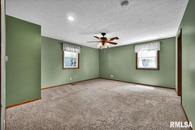 303 W 3rd Ave, Deer Creek, IL 61733 - carpeted spare room with plenty of natural light, a ceiling fan, a textured ceiling, and a smoke detector