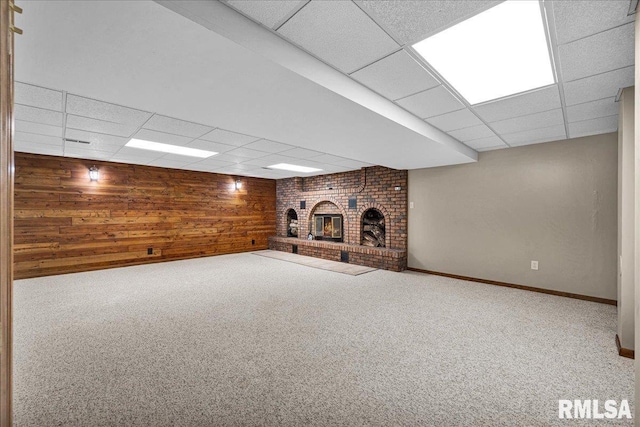 303 W 3rd Ave, Deer Creek, IL 61733 - finished basement with a drop ceiling, a fireplace, wood walls, and carpet flooring