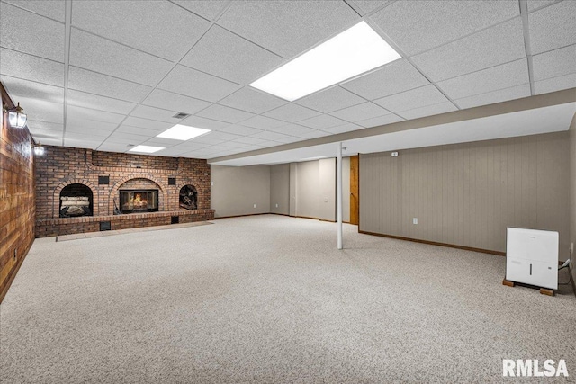 303 W 3rd Ave, Deer Creek, IL 61733 - finished basement featuring a fireplace, carpet flooring, a drop ceiling, and wooden walls