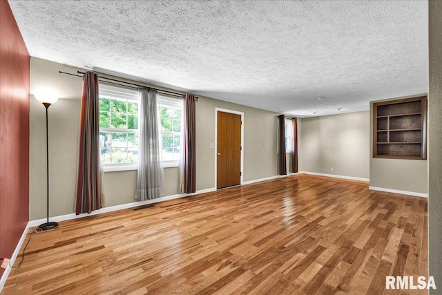 303 W 3rd Ave, Deer Creek, IL 61733 - empty room featuring wood finished floors and a textured ceiling