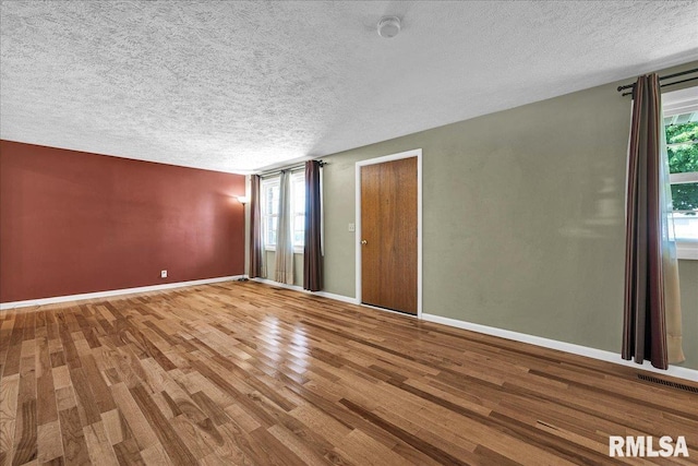 303 W 3rd Ave, Deer Creek, IL 61733 - unfurnished bedroom featuring wood finished floors and a textured ceiling