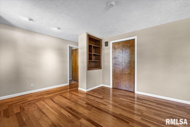 303 W 3rd Ave, Deer Creek, IL 61733 - unfurnished room featuring wood finished floors and a textured ceiling