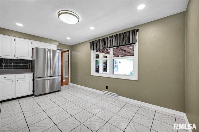 303 W 3rd Ave, Deer Creek, IL 61733 - kitchen with freestanding refrigerator, dark countertops, backsplash, white cabinets, and recessed lighting