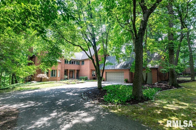 408 W Ravinwoods Rd, Peoria, IL 61615 - view of front of home featuring brick siding, concrete driveway, and a garage