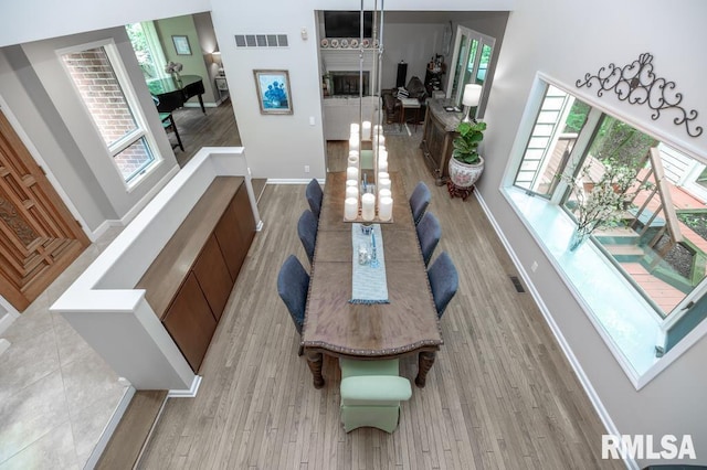 408 W Ravinwoods Rd, Peoria, IL 61615 - dining space with light wood-type flooring and baseboards