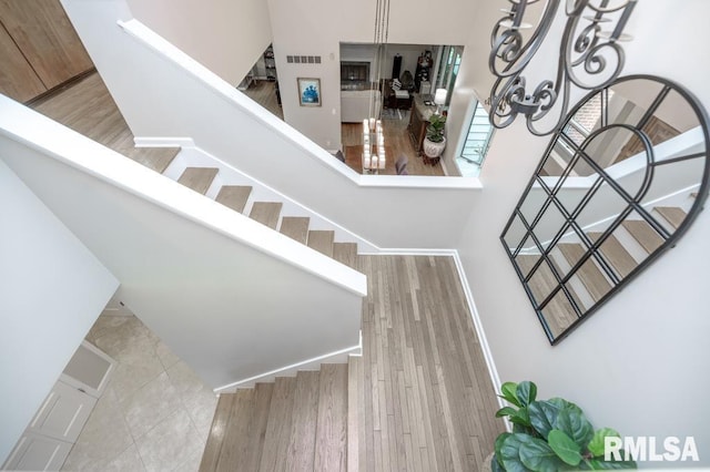 408 W Ravinwoods Rd, Peoria, IL 61615 - stairway featuring wood finished floors and baseboards