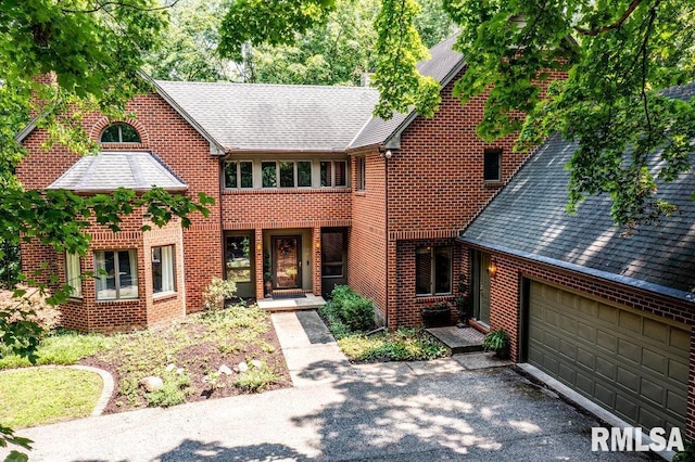 408 W Ravinwoods Rd, Peoria, IL 61615 - view of front of property featuring a shingled roof, driveway, brick siding, and an attached garage