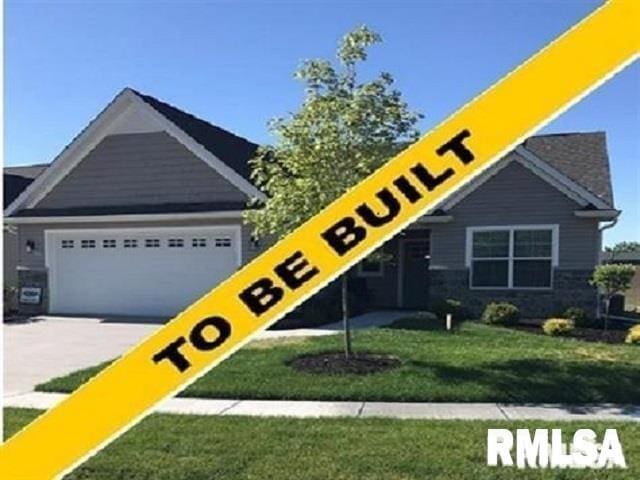 view of front of home with a front yard and a garage