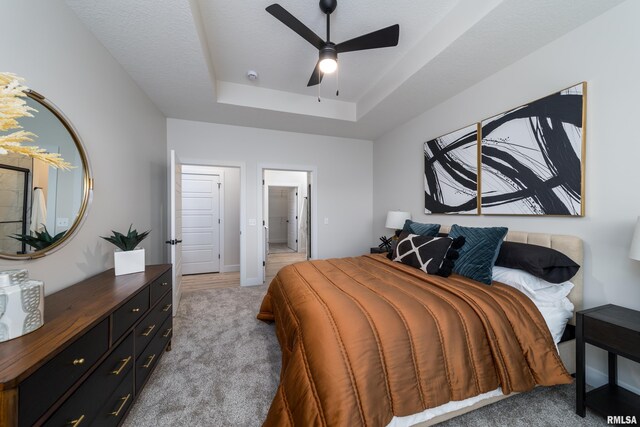 361 E Donahue St, Eldridge, IA 52748 - bedroom featuring light carpet, a raised ceiling, and a ceiling fan