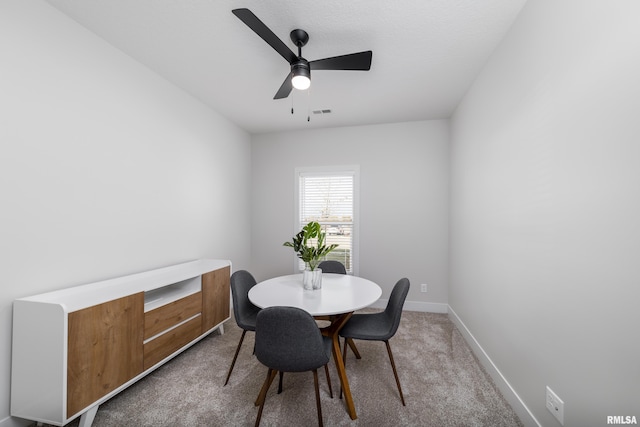 dining room featuring ceiling fan and carpet