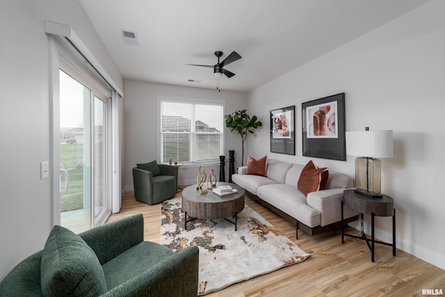 living room with light wood-type flooring and ceiling fan