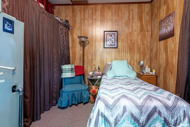 bedroom featuring wooden walls and carpet flooring