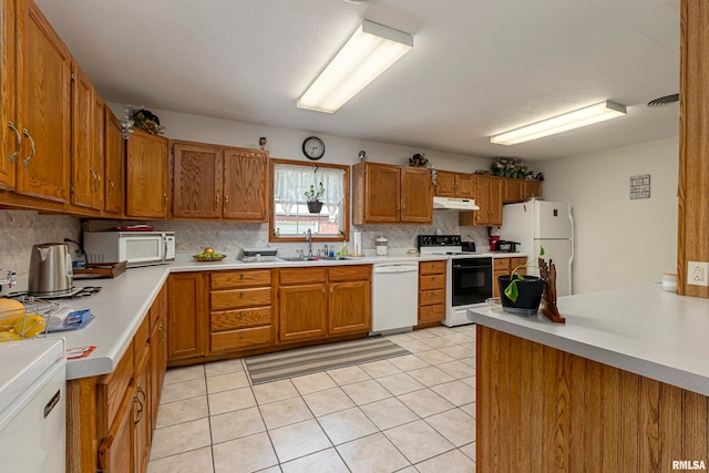 kitchen with white appliances, sink, tasteful backsplash, and light tile flooring