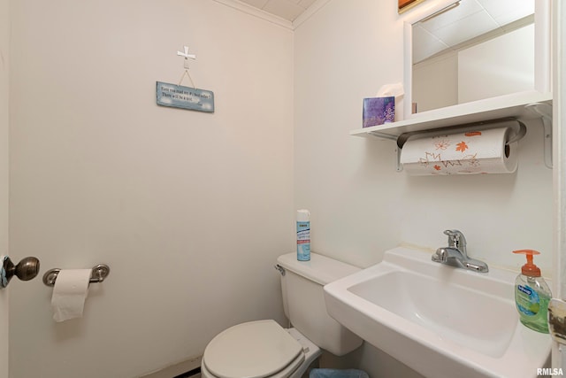 bathroom with crown molding, sink, and toilet