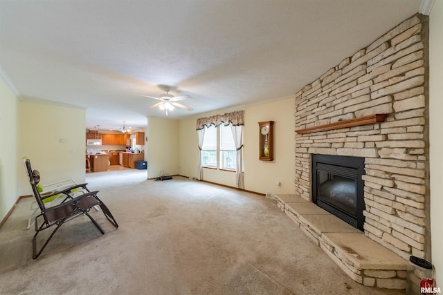 unfurnished room featuring light carpet, a stone fireplace, ceiling fan, and crown molding