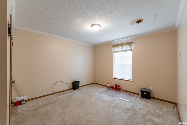 spare room with a textured ceiling, ornamental molding, and light colored carpet