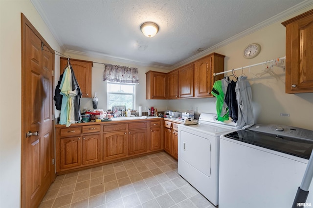 laundry room featuring light tile flooring, cabinets, sink, separate washer and dryer, and crown molding