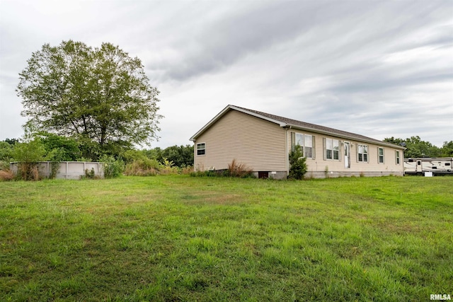 view of side of home with a lawn