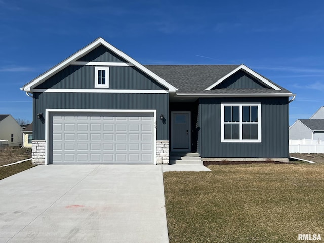 view of front of property with a front yard and a garage