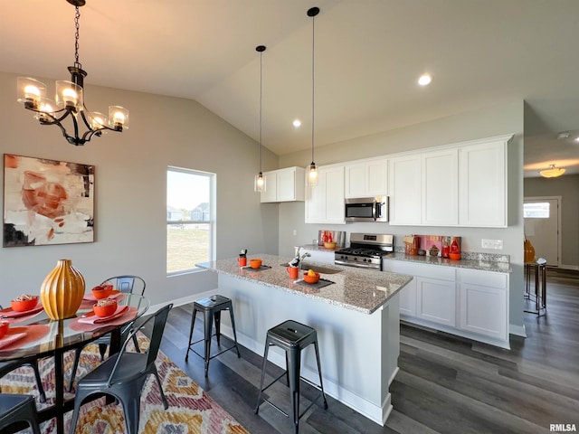 kitchen with white cabinetry, dark wood-type flooring, vaulted ceiling, and appliances with stainless steel finishes