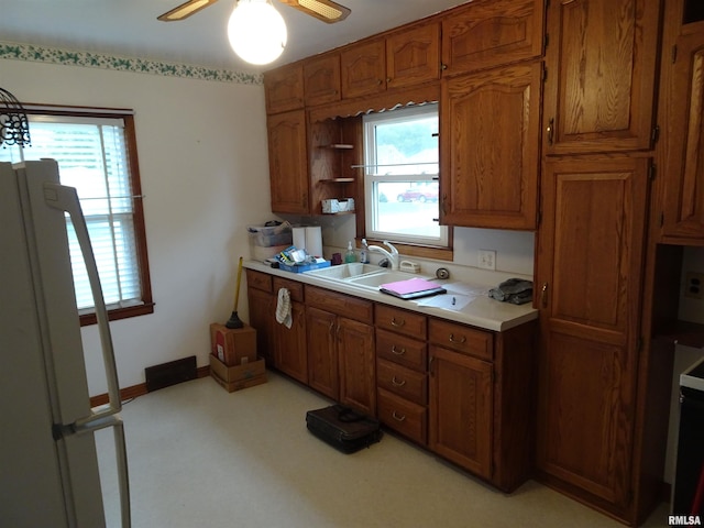 kitchen with ceiling fan, refrigerator, and sink