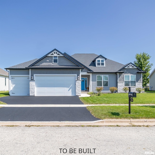 view of front of property with aphalt driveway, a garage, a shingled roof, stone siding, and a front lawn