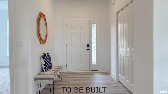 entryway with light wood-style floors and baseboards