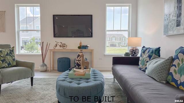 living area featuring wood finished floors and baseboards