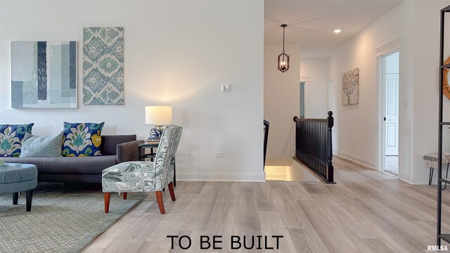 living room featuring light wood finished floors, baseboards, an inviting chandelier, and recessed lighting