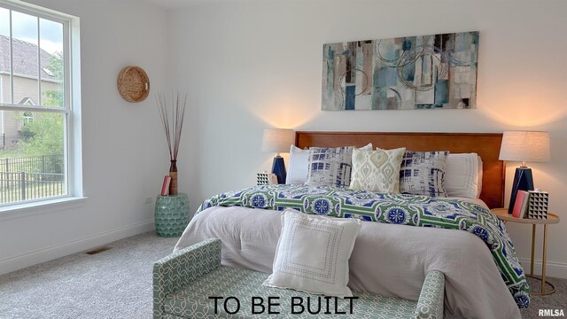 carpeted bedroom with visible vents and baseboards